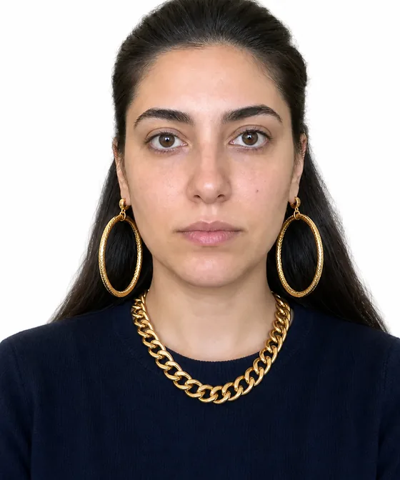 Incorrect ID photo example with large earrings and a necklace